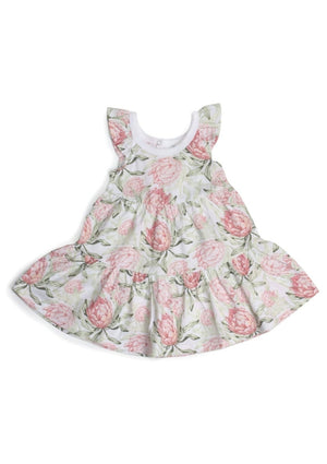 Cotton Frill Dress - Botanical, by Little Be Watch a child explore a world of wonder that’s evergreen - fresh and new, yet everlasting. Your little gardener can offer a lesson to us all in the magic of time spent in nature to inspire, delight and bring joy.  Little Bee by Dimples Evergreen 2023 Summer Collection is made using Oeko-Tex Certified Organic Cotton. Combining a Protea print with a classic stripe, you’ll have endless options for dressing your little one.