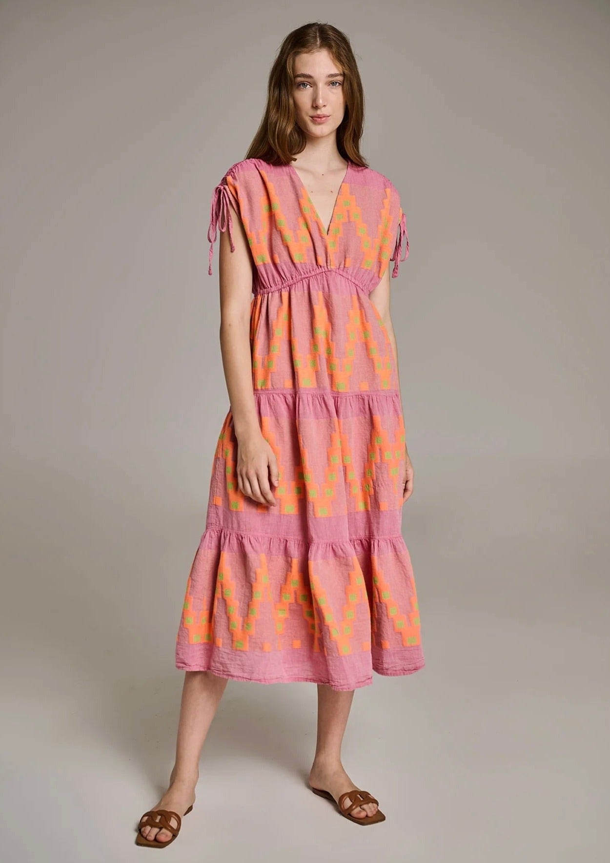 Devotion Topazio Dress - Pink/Orange The Topazio dress by brand Devotion Twins is a perfect choice for your summer getaway. This dress is crafted with great attention to detail, using a traditional loom technique that adds a touch of artistry to the garment.