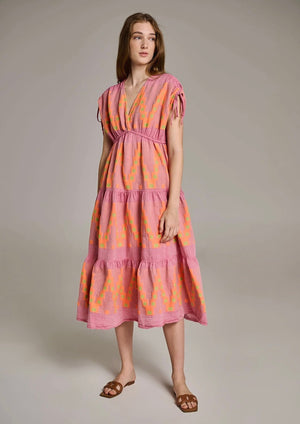 Devotion Topazio Dress - Pink/Orange The Topazio dress by brand Devotion Twins is a perfect choice for your summer getaway. This dress is crafted with great attention to detail, using a traditional loom technique that adds a touch of artistry to the garment.