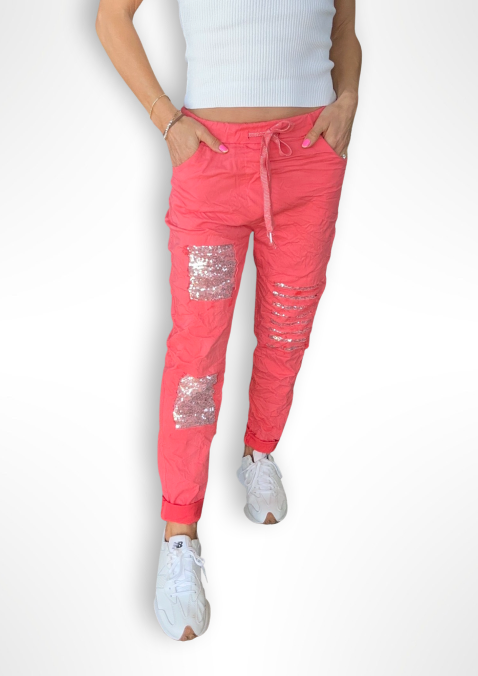 Milanese Sequin Pant - Coral, by Amici Our Milanese Sequin Pant are the perfect pant to get into that happy spring vibe! With a blend of viscose and stretch material for superior comfort, these hip joggers feature sequin detailing  and drawstring waist. Stand out in style for your weekend ahead with these fabulous joggers!