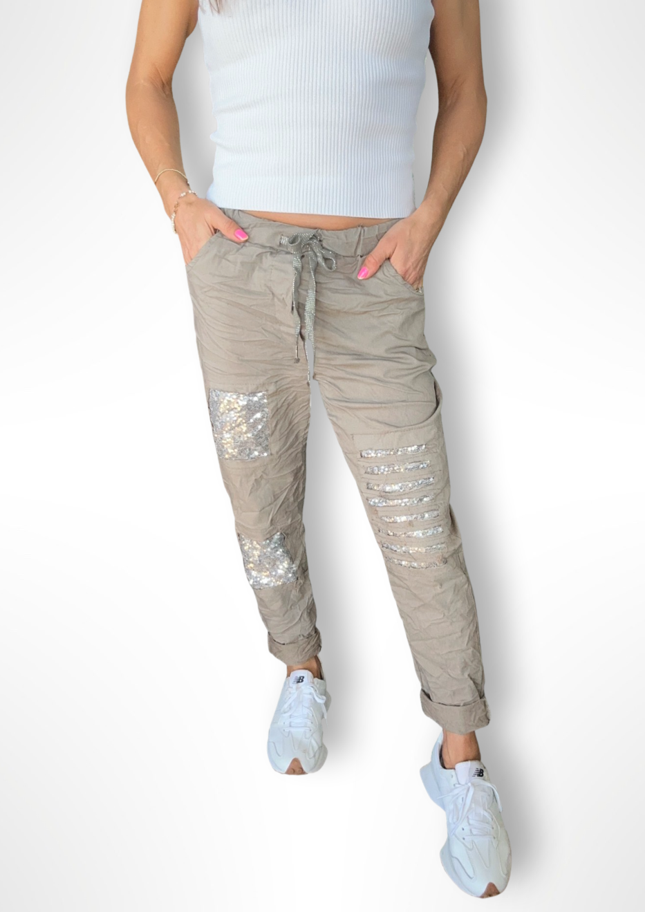 Milanese Sequin Pant - Mud, by Amici Our Milanese Sequin Pant are the perfect pant to get into that happy weekend vibe! With a blend of viscose and stretch material for superior comfort, these hip joggers feature sequin detailing  and drawstring waist. Stand out in style for your weekend ahead with these fabulous joggers!  Viscose blend Drawstring waist Funky sequin design Wear mid or low rise