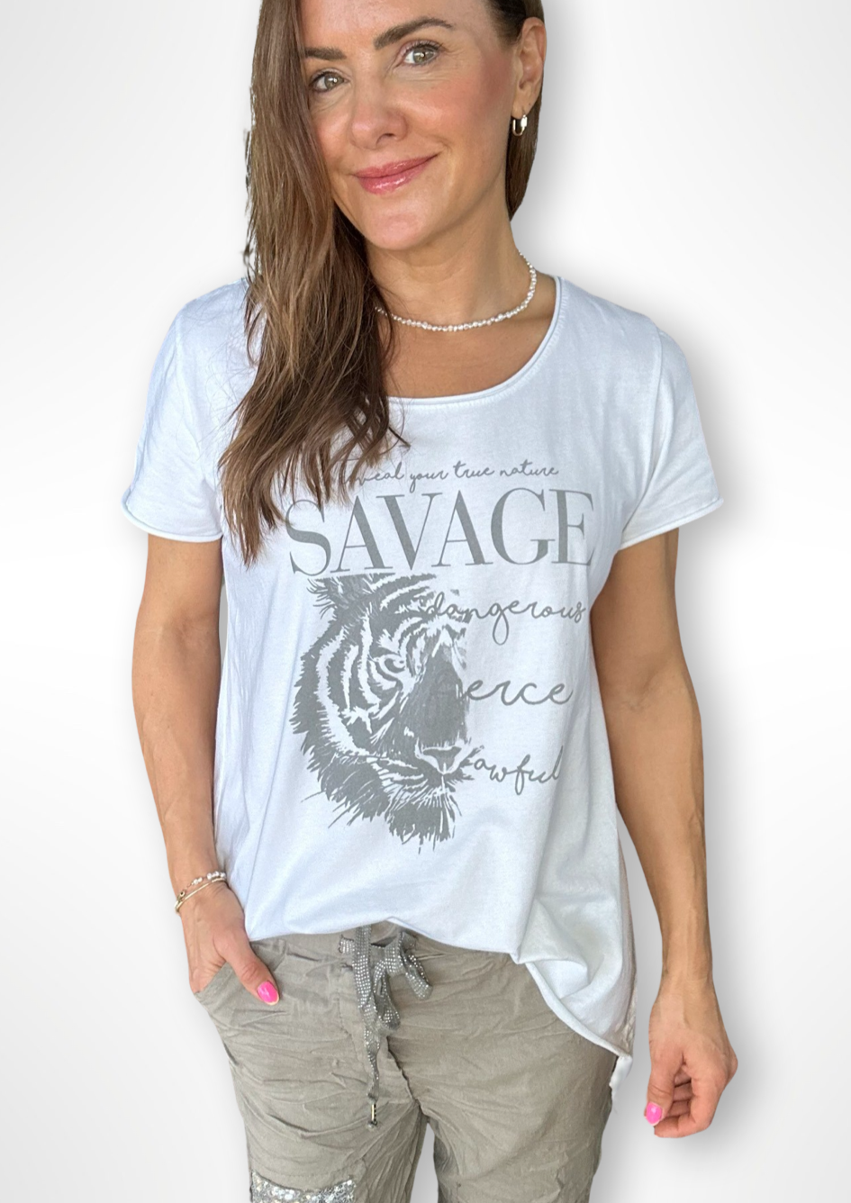 Fierce Hi Lo Tee - White, by Amici Elevate your casual wardrobe with the Fierce Hi Lo Tee.  This lightweight tee is made from 100% cotton and features fierce design, and hi lo hem, making it the perfect weekend tee with jeans, denim shorts or our fab Milanese Jogger Pants!