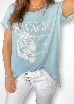 Fierce Hi Lo Tee - Light Blue, by Amici Elevate your casual wardrobe with the Fierce Hi Lo Tee.  This lightweight tee is made from 100% cotton and features fierce design, and hi lo hem, making it the perfect weekend tee with jeans, denim shorts or our fab Milanese Jogger Pants!