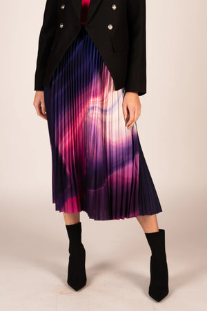 Lilian Pleat Skirt - Prism, by We Are The Others  Add a vibrant touch to your wardrobe with the Lilian Pleat Skirt in Prism print, styled effortlessly with a solid-coloured top and sneakers for a playful yet polished look.