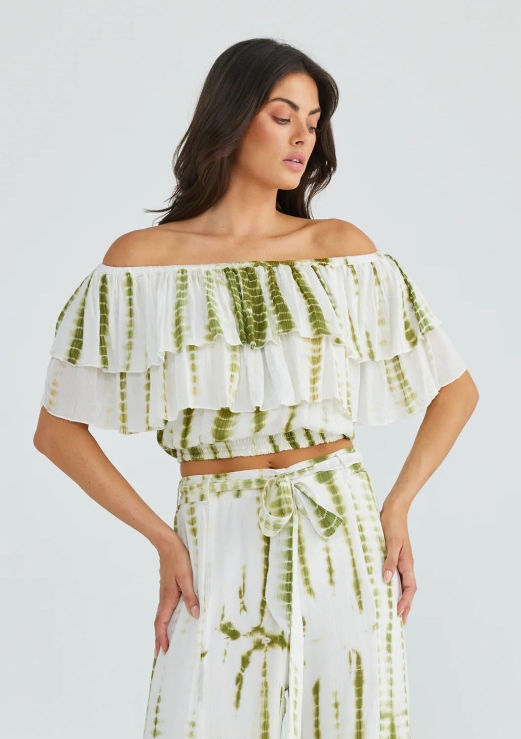 Road Trip Top - Olive Tie Dye, by Talisman Teamed with sun kissed skin and tousled hair, the Road Trip Top is the ultimate blend of feminine and free-spirited. This flirty crop features a double frill bodice and is elasticated through the neck edge and hem to keep the off-shoulder look in place. Take this playful piece from the beach to the bar with ease!  Can be worn on or off the shoulder, or asymmetrically on one shoulder.