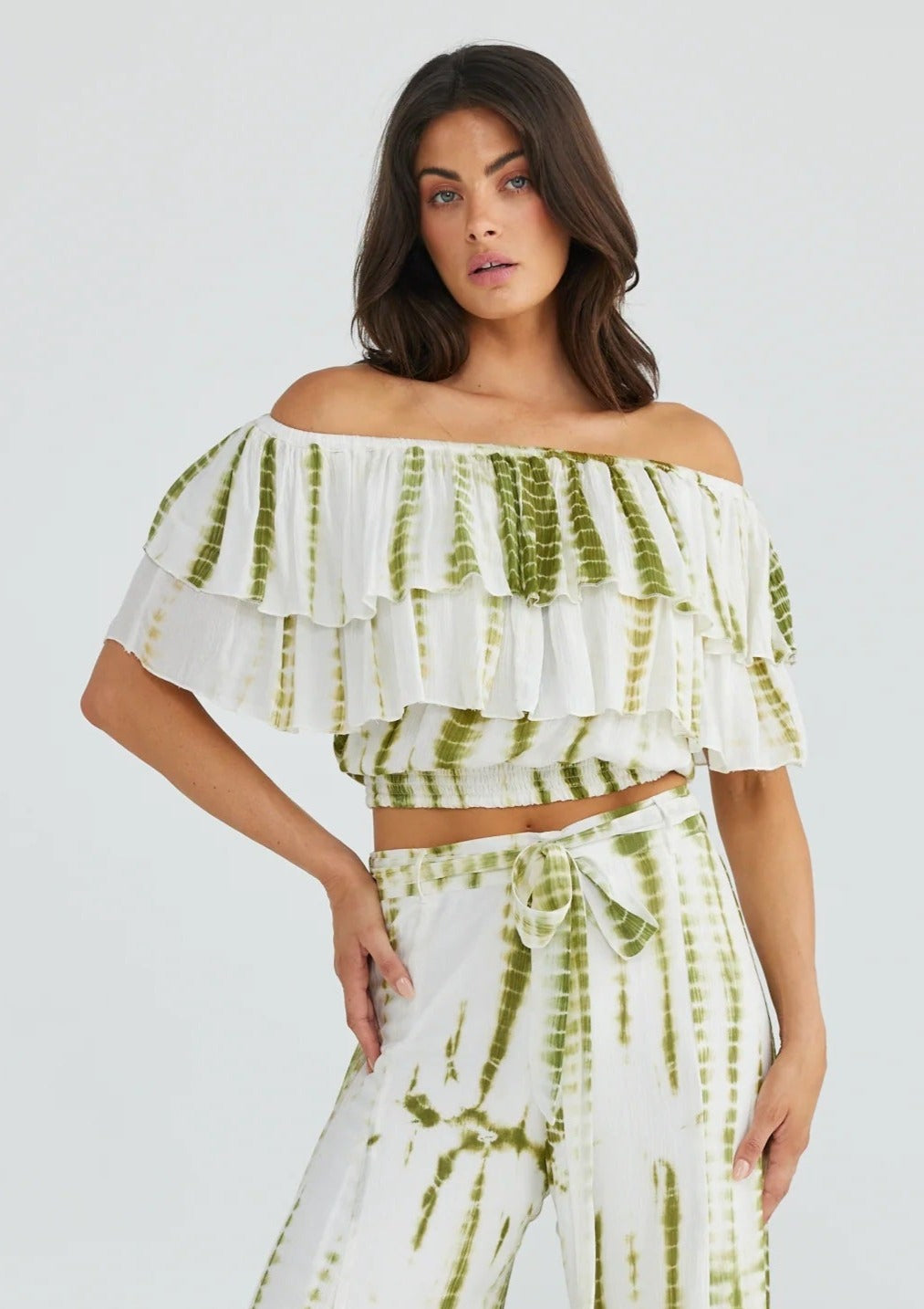Road Trip Top - Olive Tie Dye, by Talisman Teamed with sun kissed skin and tousled hair, the Road Trip Top is the ultimate blend of feminine and free-spirited. This flirty crop features a double frill bodice and is elasticated through the neck edge and hem to keep the off-shoulder look in place. Take this playful piece from the beach to the bar with ease!  Can be worn on or off the shoulder, or asymmetrically on one shoulder.