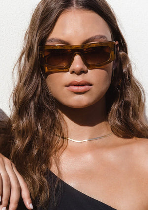 Veil - Crystal Toffee/Brown Polarised, by Bask Details:  Featuring a sleek shield silhouette, the Veil is designed for the sun-seekers who love to push the boundaries of fashion. Available in 3 contemporary colour ways, Veil is crafted with an acetate frame, luxurious temple detailing and fitted with a TAC gradient polarised lens. This style is your go-to chic, yet sun-smart, eyewear solution.