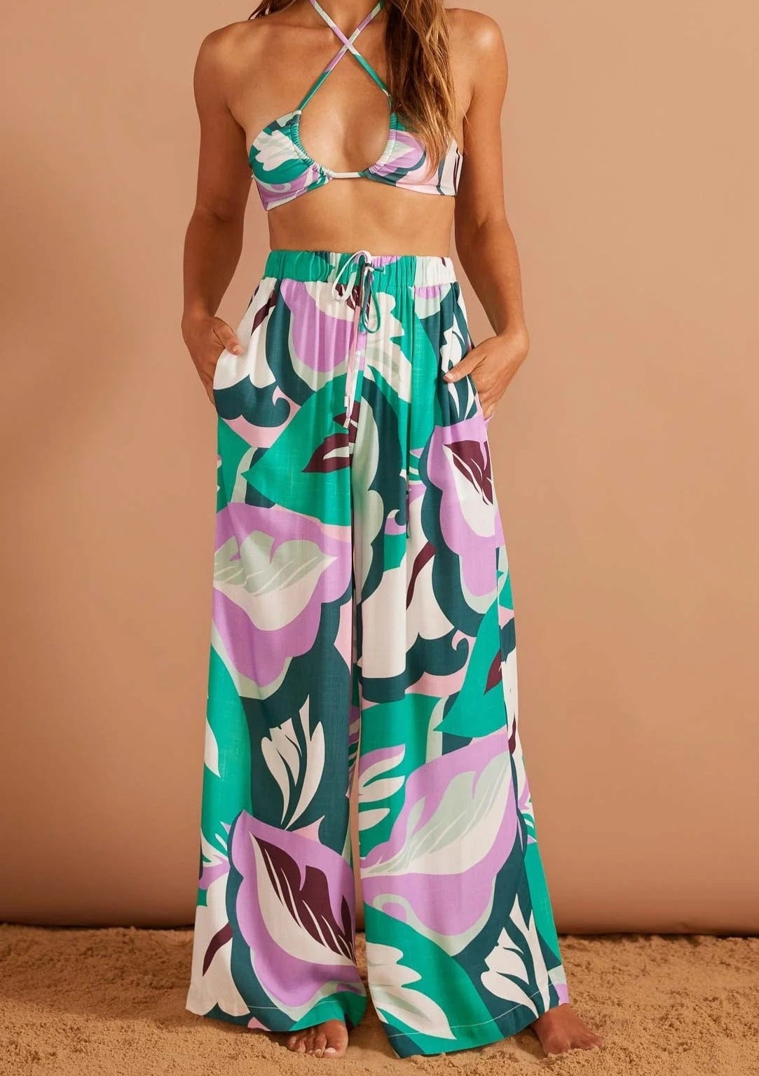 Brisa Marina Pant - Lilac/Green, by MinkPink Details:  - Wide-leg drawstring pants in exclusive abstract palm print - High waisted with side pockets. - Encased elastic waistband with self-fabric drawstring - Pair back with Brisa Marina Shirt. - Designed in Sydney, Australia