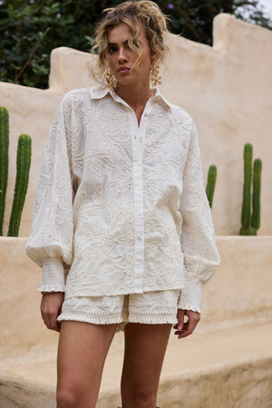 Chantilly Short - Natural Embroidery, by Talisman
Sits at natural waist

Elasticated waistband with drawstring tie

Side pockets

Cotton lattice fringe trim details on hem

Embroidered cotton fabrication

Lined