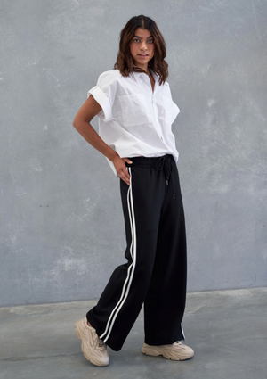 Wide Leg Pant - Black, by Style Laundry It's the year of the wide leg pant!  Wide-leg pants is super flattering on many body types, as they create a balanced silhouette and elongate the legs.  These Style Laundry pants will tick all the boxes  Heavy cotton jersey with side white stripes, pocket seams and tie elasticated waist