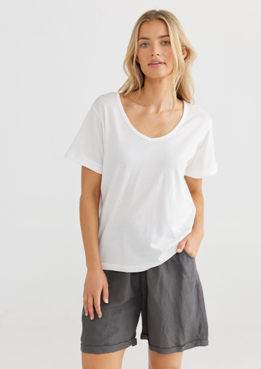Kasai S/S Tee - White, by Shanty Corp. Details:  • V SHAPE NECKLINE • SHORT SLEEVES • RELAXED FIT • HIGH LOW HEM