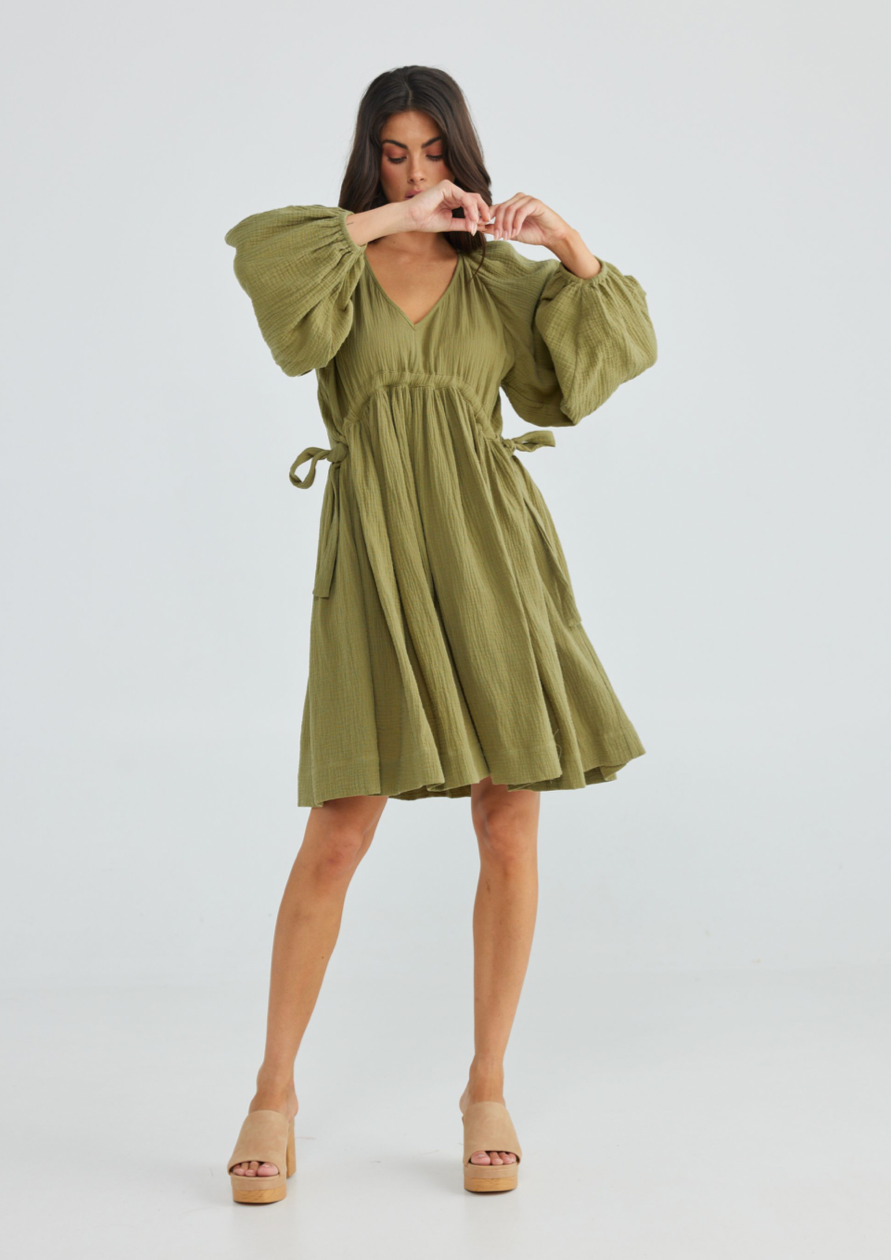 Gaia Dress - Olive, by Talisman  •VEE NECK •RAGLAN PEASANT SLEEVE WITH ELASTIC CUFF •GATHERING OVER SHOULDER •UNDER BUST CHANNEL WITH FUNCTIONAL •DRAWSTRINGS - TIED AT SIDES •GATHERED, FULL HEM •ABOVE KNEE LENGTH