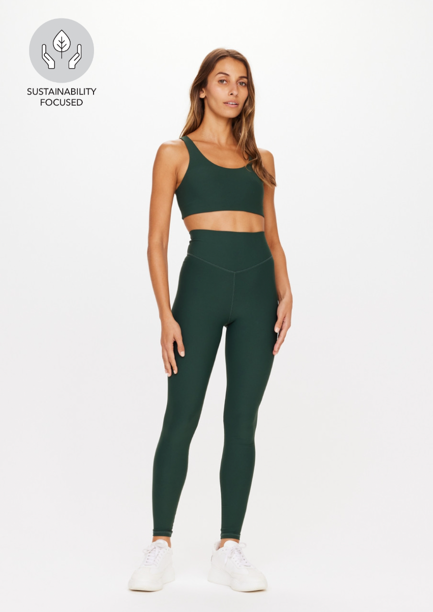 Peached 28" High Rise Pant - British Racing Green, by The Upside Stride ahead in our Peached High Rise 28In Pant.  High waisted V front full length 28" leg Printed arrow logo at centre back Recycled soft peached with a brushed hand feel in British Racing Green Moisture wicking Breathable, quick drying and extra soft