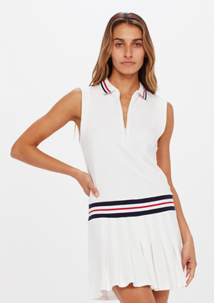 Love Fay Dress - White, by The Upside Play hard to get in our Love Fay Dress  Organic cotton pique fabrication Half zip tennis dress with pleated skirt Stripe rib collar & waistband Embroidered arrow logo at back neck Built in shorts are not included with this dress, so you can style it however you'd like