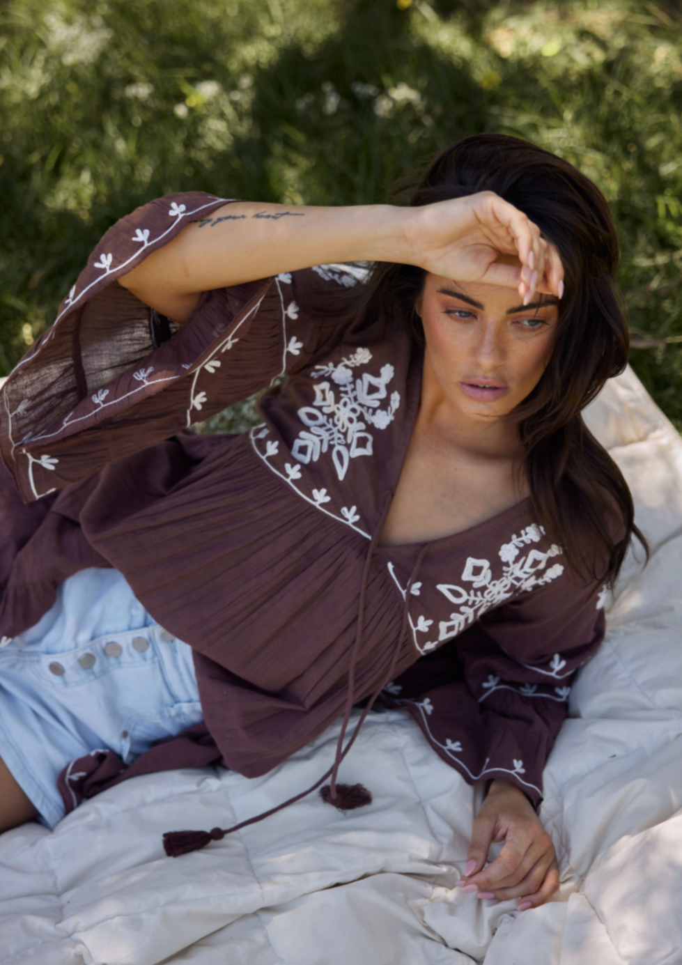 Aneesa Tunic - Cocoa, by Talisman Rendered in a breathable lightweight cotton gauze, this is a style that'll be cherished for seasons to come. Embellished with floral embroidery, this simple beauty can be paired with shorts and skirts, or worn as a throw-over coming off the beach