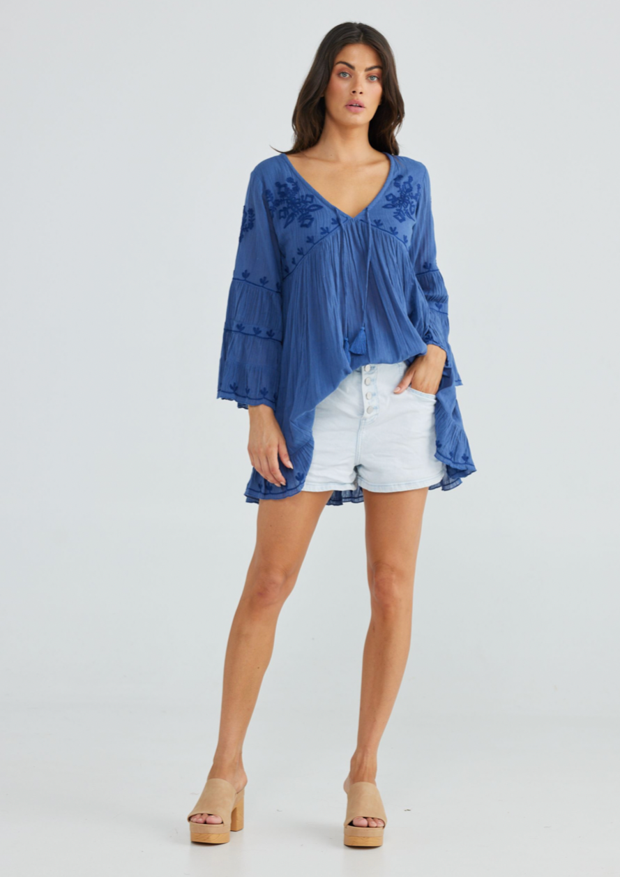 Aneesa Tunic - Sea Blue, by Talisman Rendered in a breathable lightweight cotton gauze, this is a style that'll be cherished for seasons to come. Embellished with floral embroidery, this simple beauty can be paired with shorts and skirts, or worn as a throw-over coming off the beach