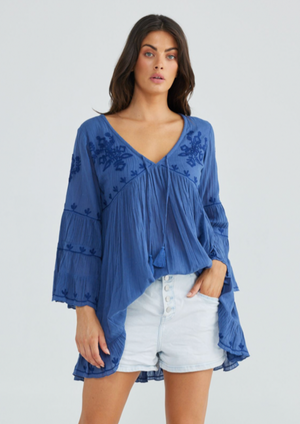 Aneesa Tunic - Sea Blue, by Talisman Rendered in a breathable lightweight cotton gauze, this is a style that'll be cherished for seasons to come. Embellished with floral embroidery, this simple beauty can be paired with shorts and skirts, or worn as a throw-over coming off the beach