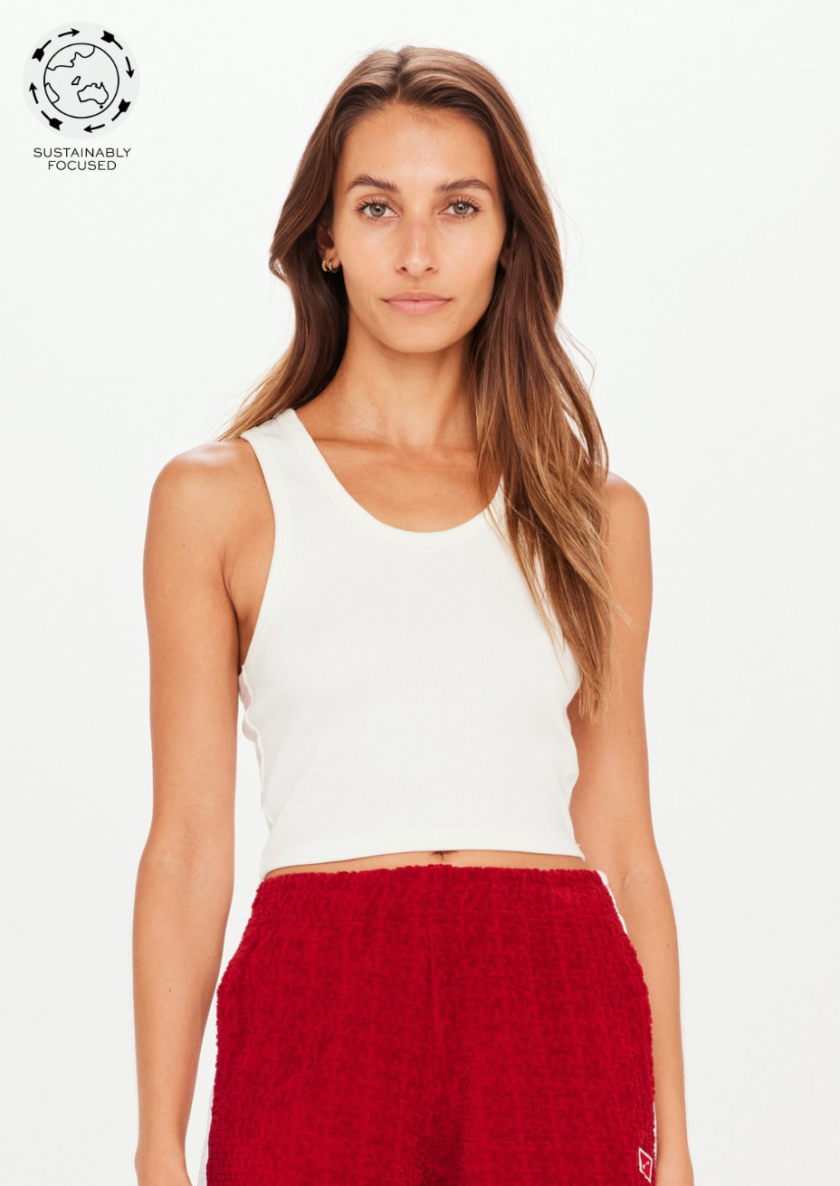 Sophie Crop Tank - White, by The Upside A classic tank you can't go past.  Cropped racer back tank Made of pure cotton rib for everyday luxe. Embroidered arrow at centre back Please refer to studio images for accurate colour of garment