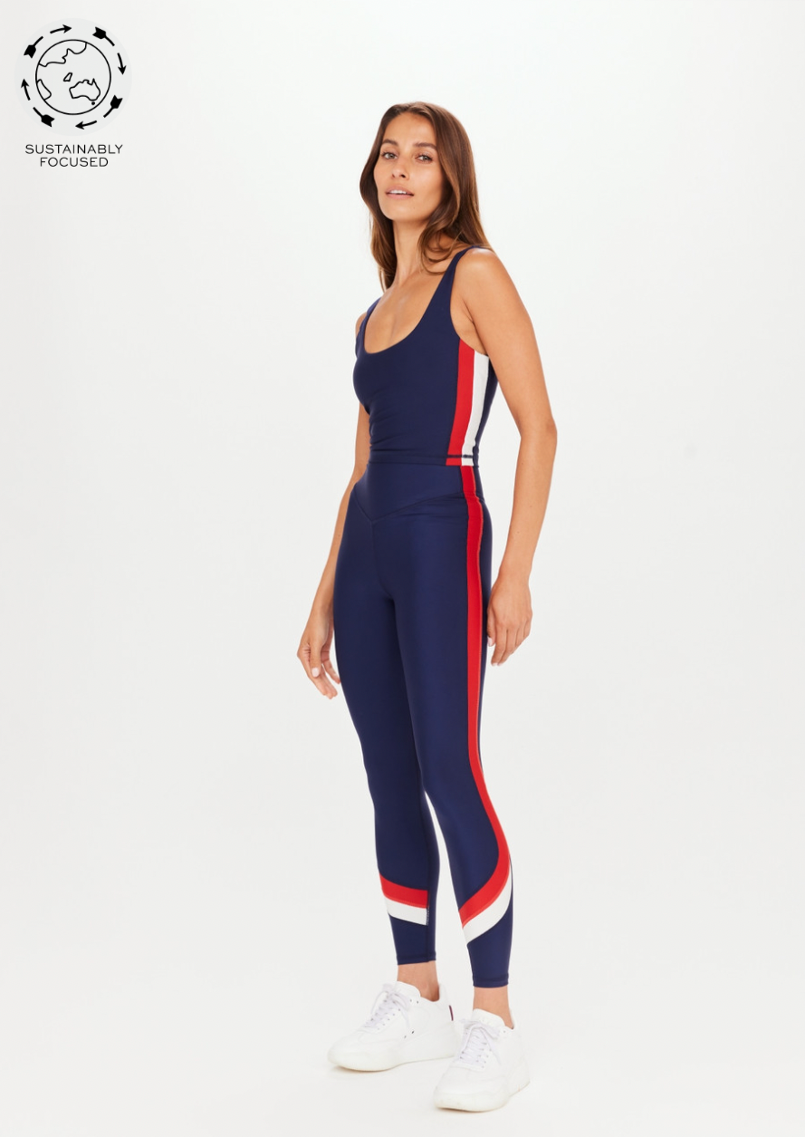 Ballpark 25" High Midi Pant - Navy, by The Upside Splice it up with a classic colour block midi pant in navy, white & red.  25" midi length legwear V shaped high-rise waistband Colour blocked in our Eco Tech performance fabric in Navy, white & red Breathable, quick drying and moisture wicking Contrast printed arrow at back waistband Please refer to studio images for accurate colour of garment