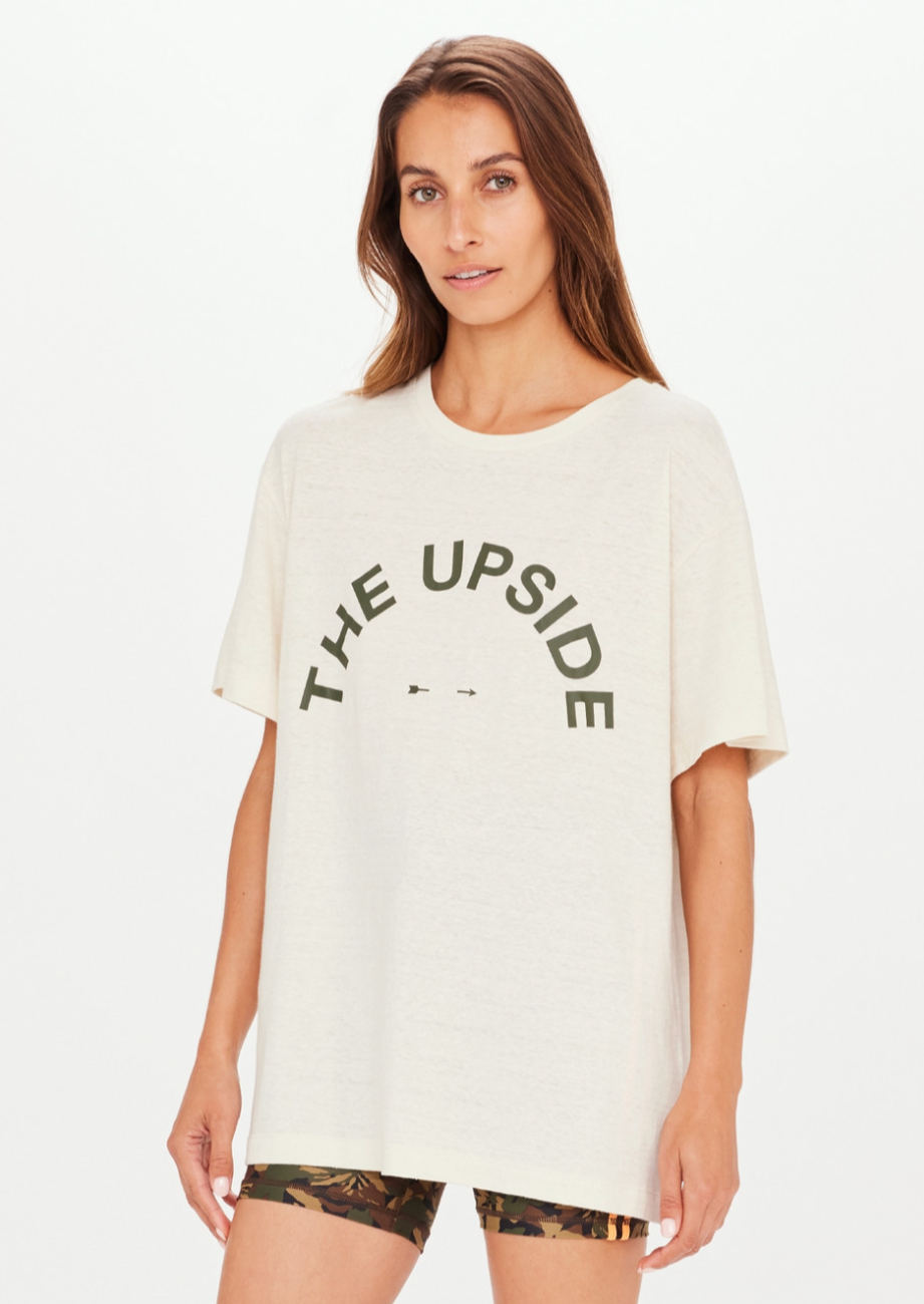 Sam Tee - Oat, by The Upside A classic tee shape to throw on over any leg.  Made with Organic Cotton hemp jersey Oversized tee shape in a natural oat colour Deep green The Upside horseshoe logo printed on chest Rib neckline Please refer to studio images for accurate colour of garment