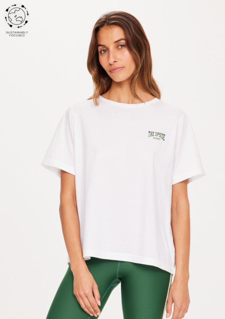Ivy League Jodhi Tee - White, by The UpsiA classic white tee with a nod to retro sports. Made with Organic Cotton jersey Classic tee shape in crisp white Ivy League The Upside Sport logo printed on chest and centre back Please refer to studio images for accurate colour of garment