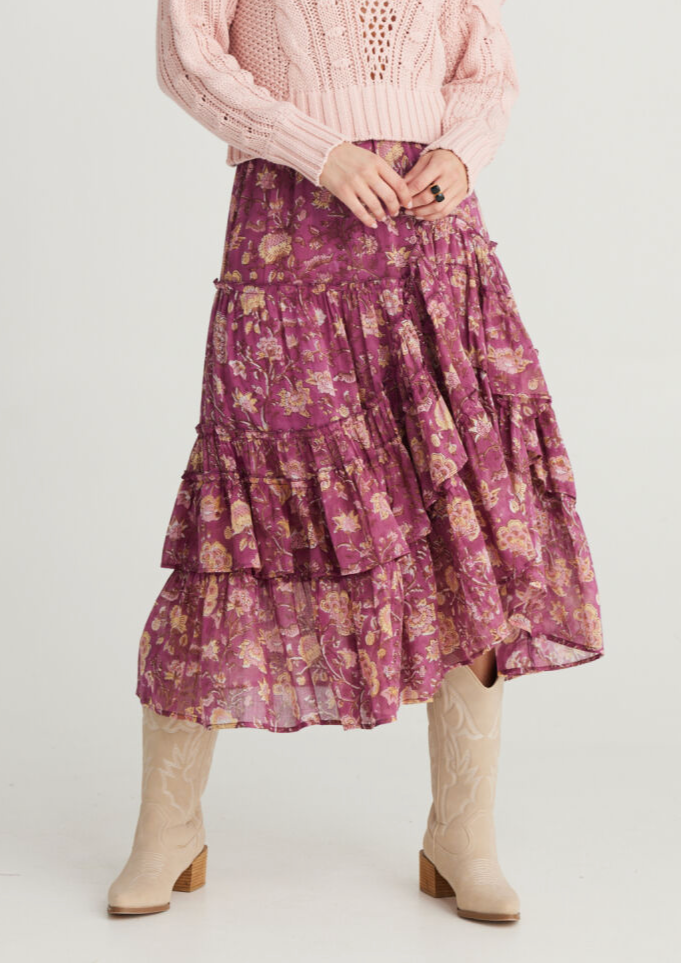 <h3>Sassy Skirt - Orchid Haze, by Talisman</h3> <p>The beloved Sassy Skirt is back in new season prints and ready to steal your heart! This flowing and feminine midi skirt will make all your boho-meets-senorita dreams come true. With layered ruffles and a full silhouette, there's no doubt she's destined for dancing!</p>