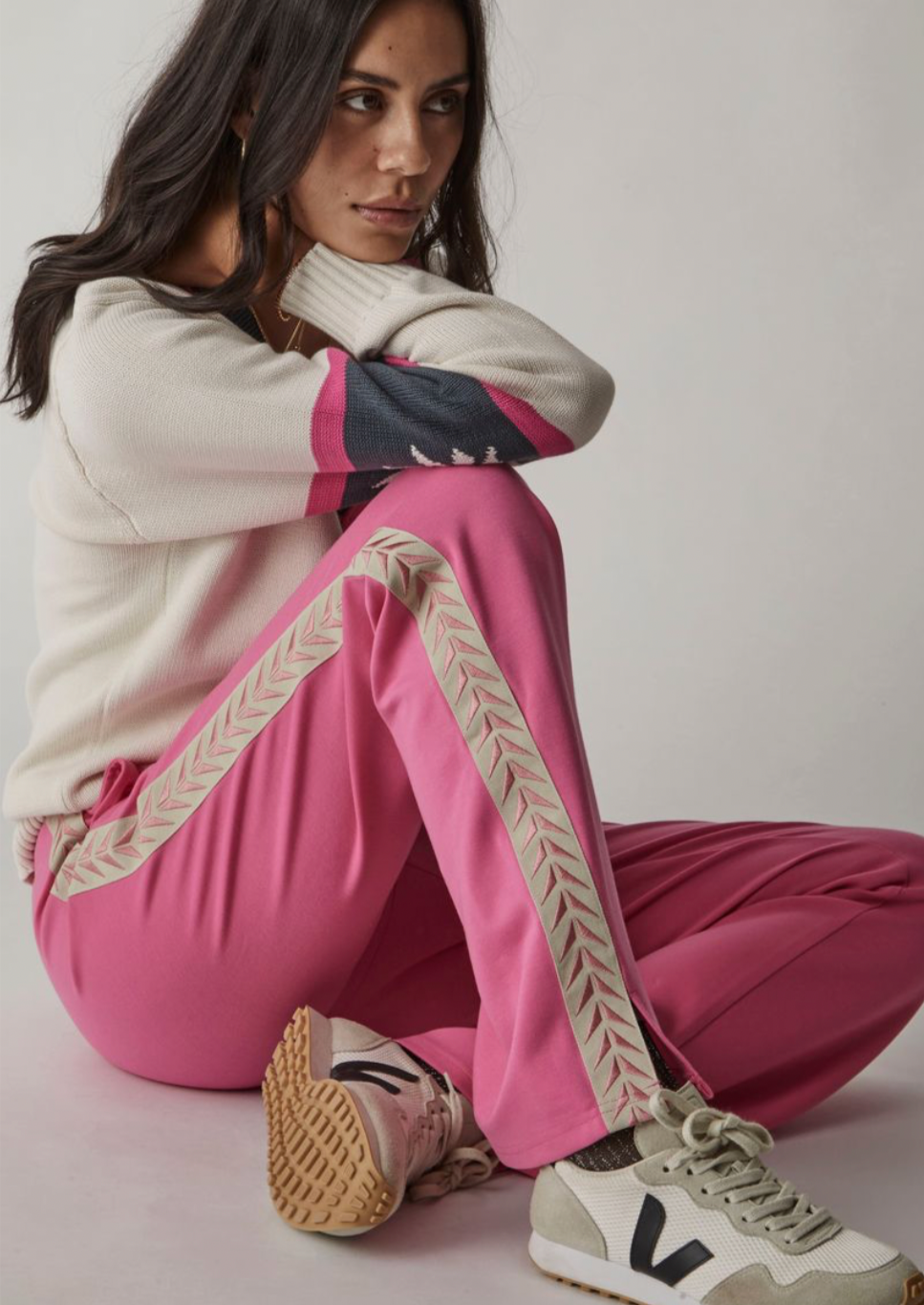 Ren Petra Flare - Hot Pink, by The Upside.    Elevate your wardrobe with the Ren Petra Flare. Flared pant with split at side. Elastic waistband. Stripe contrast tape down sides. Embroidered logo at back