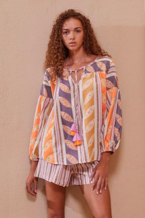 Devotion Nadia Blouse - Orange/Lilac

Oversized fit
V-neck with tassel ties
Long balloon sleeves with elasticated cuffs


Hand embroidered neon leaf design
