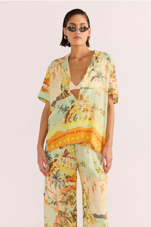 Vacanza Resort Shirt - Tropical, by MinkPink

The Vacanza Resort Shirt can be worn pool-side, as a casual everyday look or dressed up for the evening. This MINKPINK exclusive print features a sketched beachline, full of green-yellow &amp; orange hues. Pair yours with the matching Vacanza Drawstring Pant, to complete the beach to bar look.