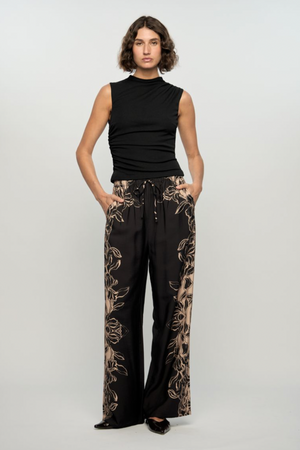 Mira Drawstring Pant - Floral, by Staple The Label

The Mira Drawstring Pant brings relaxed tailoring and statement print together. With a wide leg silhouette and floral border detailing, these lightweight pants are made for elevated off-duty days.
