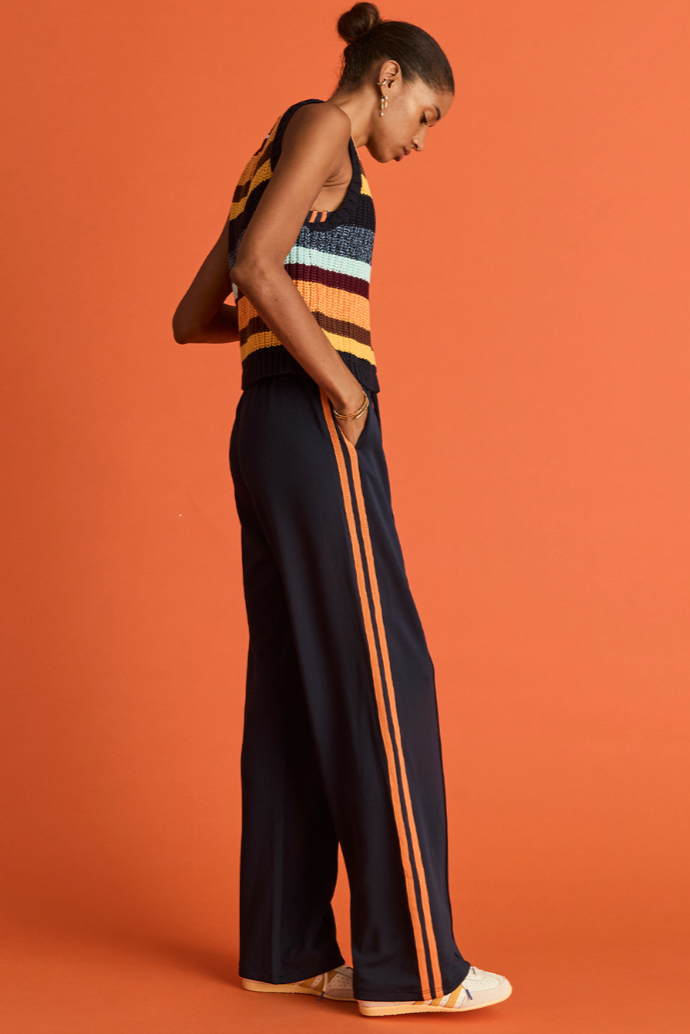 Vitesse Marnie Wide Leg Pant - Navy, by The Upside

Make every ensemble a winner with the Marnie Pant.

High rise wide leg pant with elasticated waistband and drawcord
Slinky fabrication in navy
Mesh tapes down sides in orange
Pin stitch detail at front
Side seam pockets and embroidered arrow logo
Please refer to studio images for accurate colour of garment