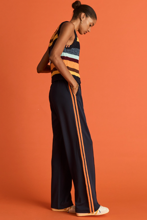 Vitesse Marnie Wide Leg Pant - Navy, by The Upside

Make every ensemble a winner with the Marnie Pant.

High rise wide leg pant with elasticated waistband and drawcord
Slinky fabrication in navy
Mesh tapes down sides in orange
Pin stitch detail at front
Side seam pockets and embroidered arrow logo
Please refer to studio images for accurate colour of garment