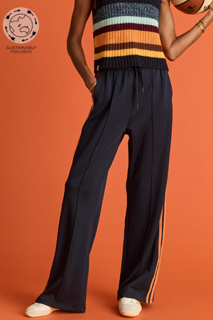 Vitesse Marnie Wide Leg Pant - Navy, by The Upside

Make every ensemble a winner with the Marnie Pant.

High rise wide leg pant with elasticated waistband and drawcord
Slinky fabrication in navy
Mesh tapes down sides in orange
Pin stitch detail at front
Side seam pockets and embroidered arrow logo
Please refer to studio images for accurate colour of garment