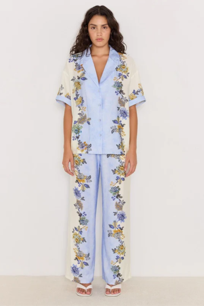 Lucia Floral Wide Leg Pants - Blue &amp; Cream, by Minkpink

The Lucia Blue &amp; Cream Floral Wide-Leg Pants bring effortless style to any resort or casual look. Cut in a relaxed, wide-leg silhouette, they feature an elasticated drawstring waist for comfort and a bold floral print along the side panels for a flattering effect. Style them with the matching Lucia Resort Shirt for a co-ord moment or pair with a simple tank for off-duty chic.
