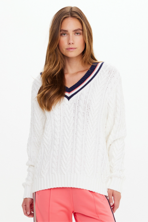 Espada Louie V Neck Sweater - Creme, by The Upside

The Espada Louie V Neck Sweater brings a playful touch to heritage knitwear

Chunky V neck cable knit sweater in cream
Organic cotton knit fabrication
Ribbed cuffs and hem
Contrast striped ribbing at neckline in navy and rose
Arrow logo pip at cuff
Please refer to studio images for accurate colour of garment