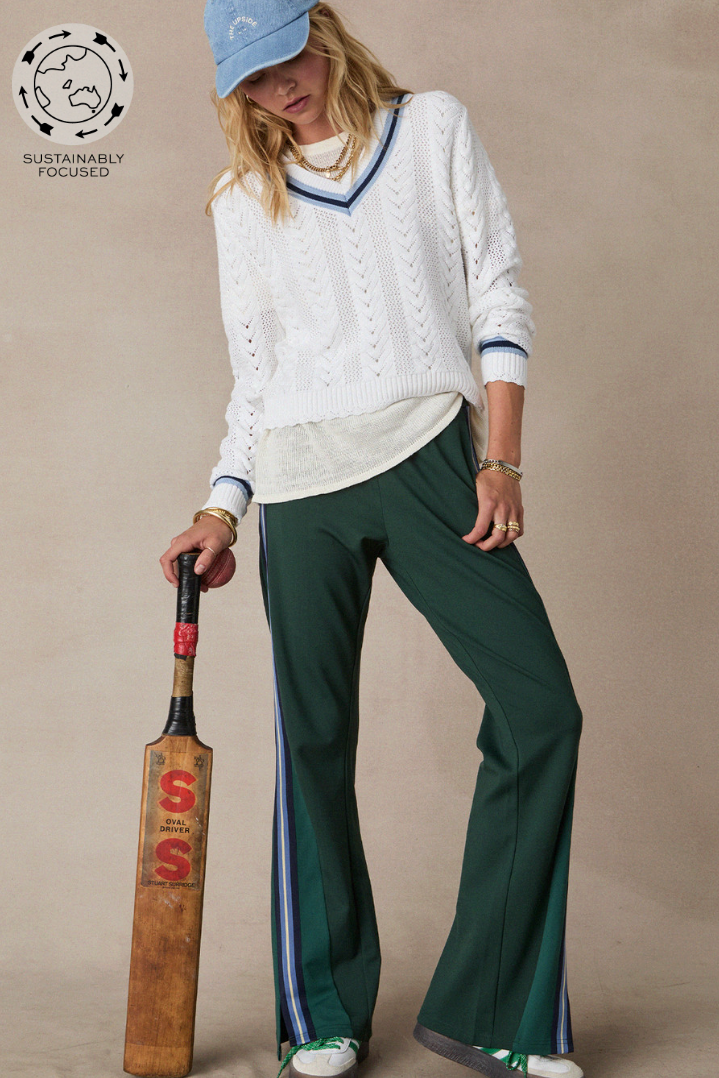 Maneki Petra Flare, by The Upside, turns retro energy into modern ease

Flared pant with splits at hem colour blocked in shades of green
Contrast knitted tape down side seams in navy, blue and cream adding a sporty touch
Contrast embroidered arrow at back
Elasticated waist
Side seam pockets
Lenzing viscose soft suiting fabrication
Please refer to studio images for accurate colour of garment