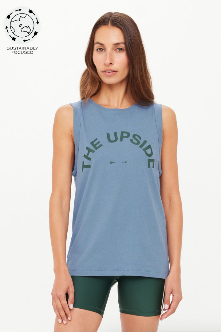 In denim blue, the Jeet Tank Top, by The Upside, delivers everyday ease with a sport edge

Made with 100% Organic Cotton jersey in soft denim blue
Relaxed fit tank with folded armhole detail
Printed The Upside logo in green at front
Soft ribbed neckline
Please refer to studio images for accurate colour of garment