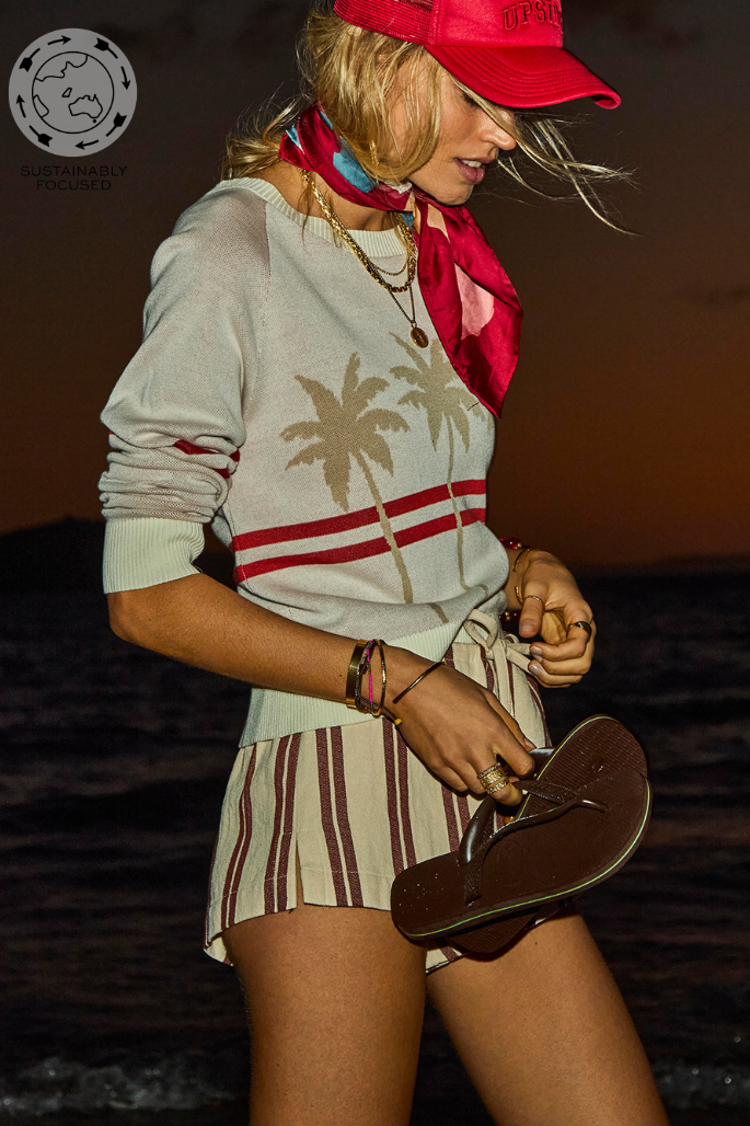 Palma Joni Knit Crew - Creme, by The Upside

The Palma Joni Knit Crew, cream cotton with bold palms and stripes in holiday red.

Knitted crew neck sweater in cream
Organic cotton fabrication
Raglan sleeves
Palm tree design on front chest with red stripes continuing around back and sleeves
Soft ribbed neckline, cuffs and hem
Please refer to studio images for accurate colour of garment