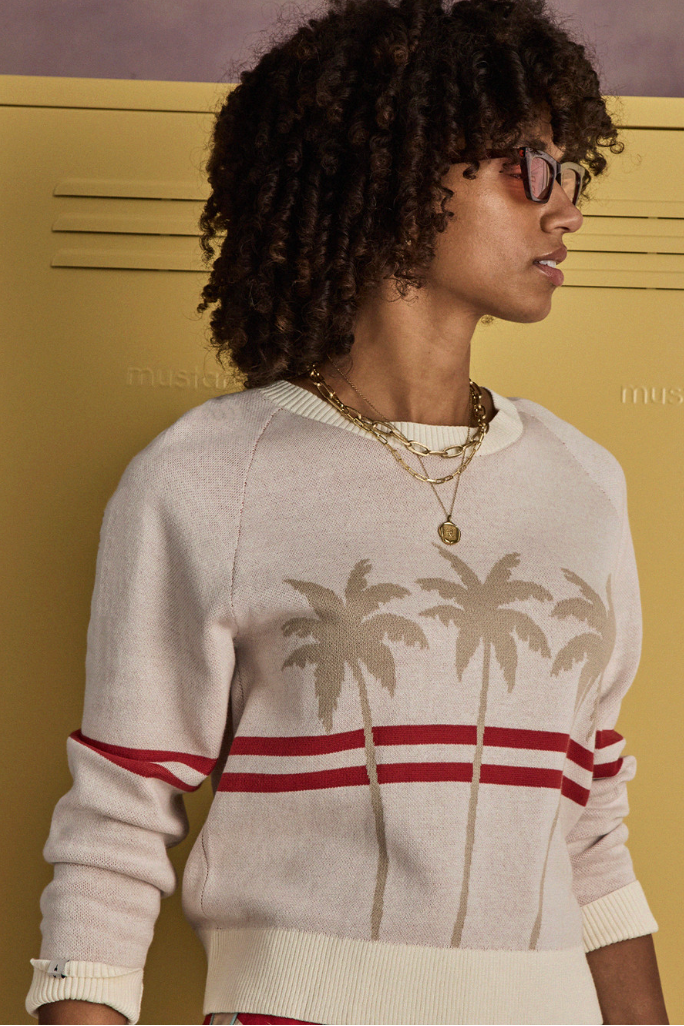 Palma Joni Knit Crew - Creme, by The Upside

The Palma Joni Knit Crew, cream cotton with bold palms and stripes in holiday red.

Knitted crew neck sweater in cream
Organic cotton fabrication
Raglan sleeves
Palm tree design on front chest with red stripes continuing around back and sleeves
Soft ribbed neckline, cuffs and hem
Please refer to studio images for accurate colour of garment