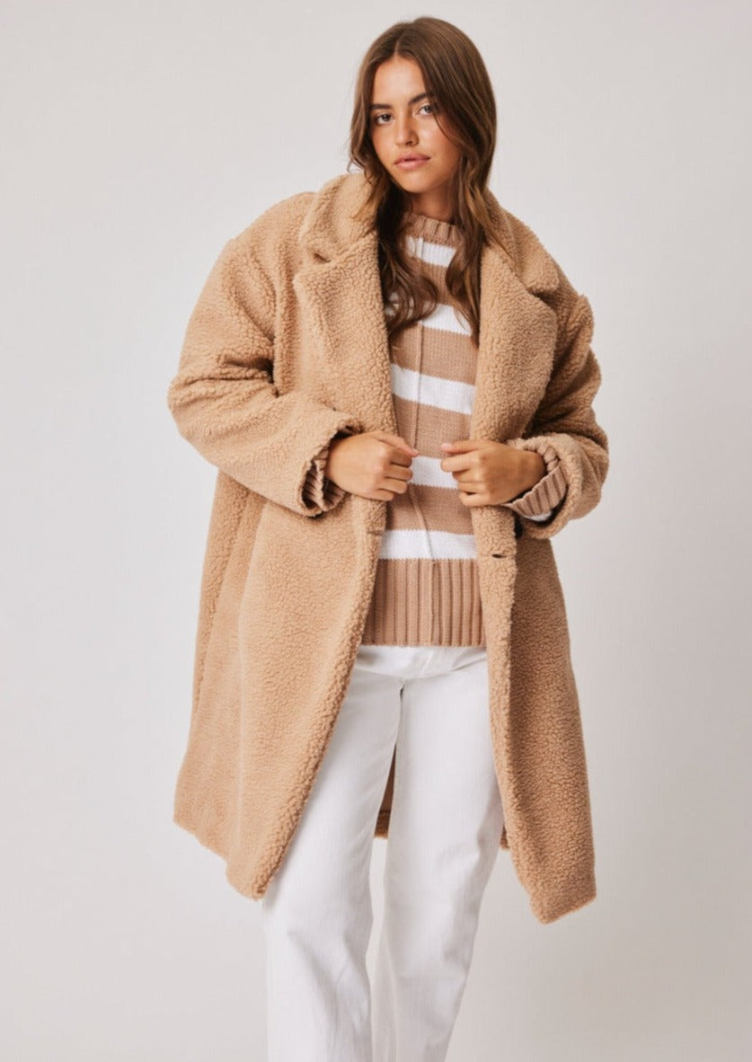 Bonnie Coat - Camel, by Cartel & Willow ﻿One of this seasons strongest trends is Sherpa. Cosy and versatile. We love the Bonnie over activewear and casual off-duty pieces.  Details:  Oversized knee length coat with notched collar Feature black tortoise buttons on the front Front side pockets