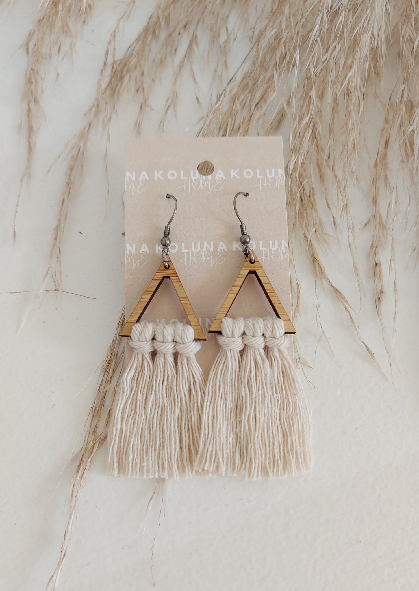 Triangle Bamboo Earrings - Natural  The Earrings that go with everything! And look gorgeous with our matching Macrame clutch/cross body bags.  Details and materials:  Triangle shape lightweight bamboo frame  Rope is 100% Recycled Cotton Hooks are surgical steel  Handmade in NZ