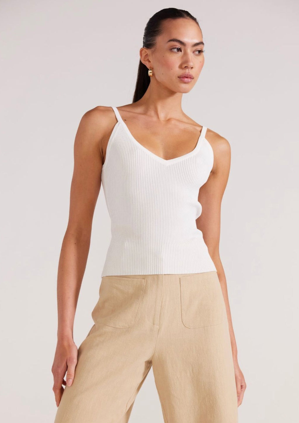 Anica Knit Singlet - White, by Staple The Label A staple in the wardrobe, the Anica Knit Singlet is a versatile everyday piece. Featuring a fitted silhouette, and a v-neckline, this singlet has been crafted from a ribbed knit making it comfortable to wear.  - v-neckline - Fitted silhouette - Full length - Knit fabrication - Designed in Sydney
