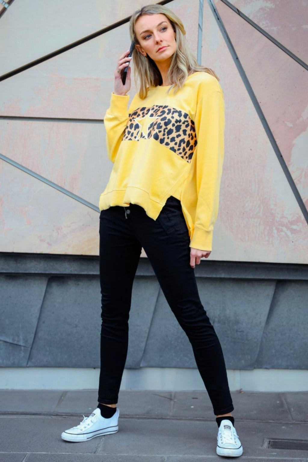 Ulverstone Crew - Butterscotch/Leopard, by 3rd Story Feel laid-back and chic in this lustrous lounge pullover.  This sweatshirt is made from a super soft, luxe 100% cotton in a trendy butterscotch hue. Perfect for cuddling and laying around all day and night in.  This crew neck features a leopard pattern print, an easy fit, long sleeves, and a slit raw hem, making for an elevated separate that can be worn out on that necessary coffee run. Pairs perfectly with joggers and jeans!