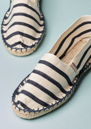 The original Espadrij flat shoes with a solid rubber sole with Beige and Navy Stripes.