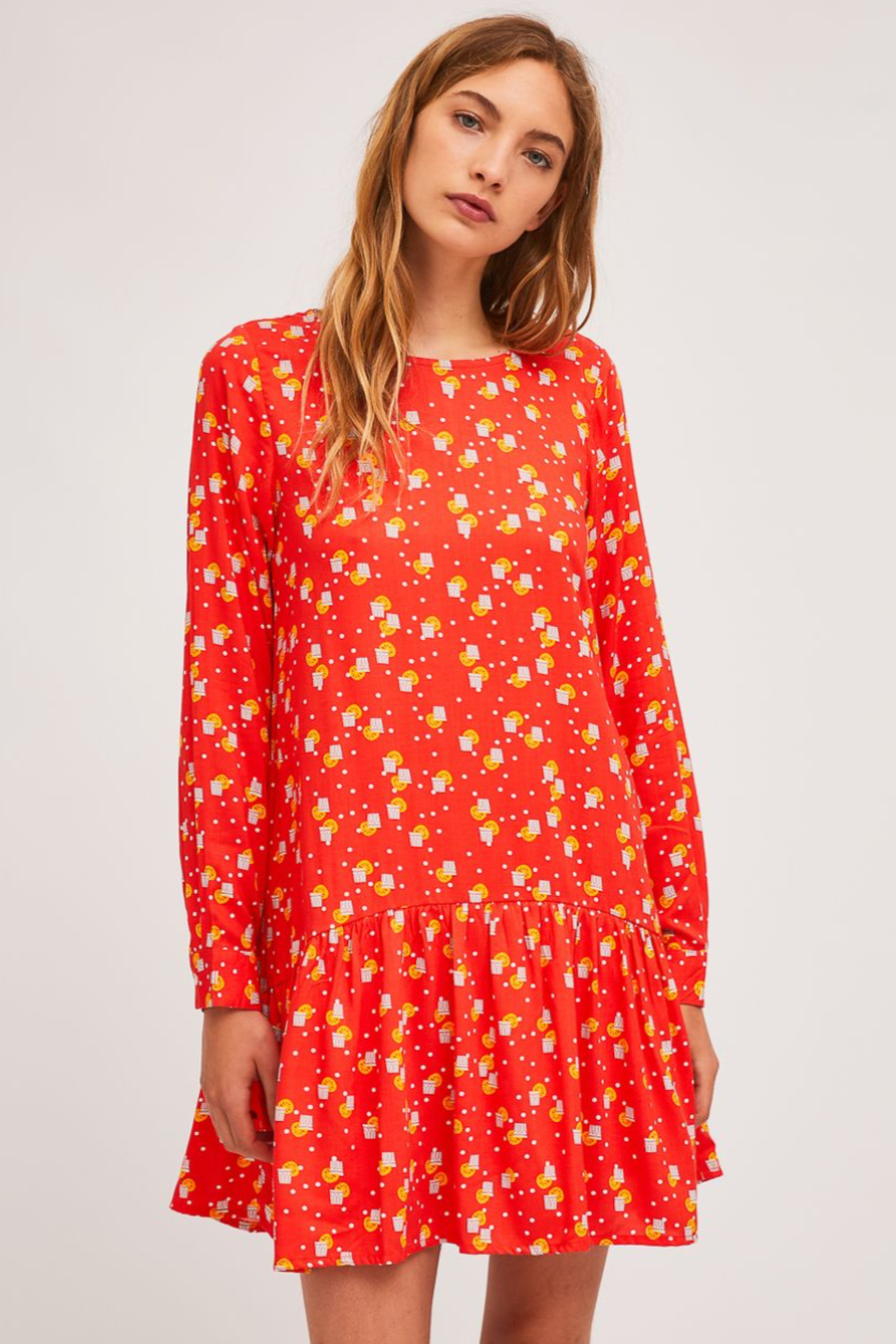 When Life Gives you Lemons Dress, by Campania Fantastica  We love everything from this quirky, artsy Spanish label!  The WLGYL dress, is the perfect throw on. This versatile dress can be dressed up or down and features a dropped waist with ruffled skirt, long sleeves and a button opening at the centre back.  With an all-over quirky lemonade print (or maybe it's a Gin Fizz?), and scarlet base, you'll be the life of the party for sure!  100% Viscose