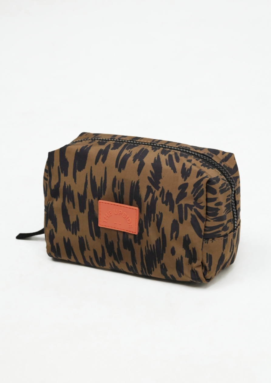 Tropical Leo Cosmetic Pouch, by The Upside  Stash your precious pieces in our Tropical Leo Cosmetic Pouch..  Custom leopard print cosmetic pouch. Ideal for everyday use and travel. Rubber patch logo. Chunky zip closure.