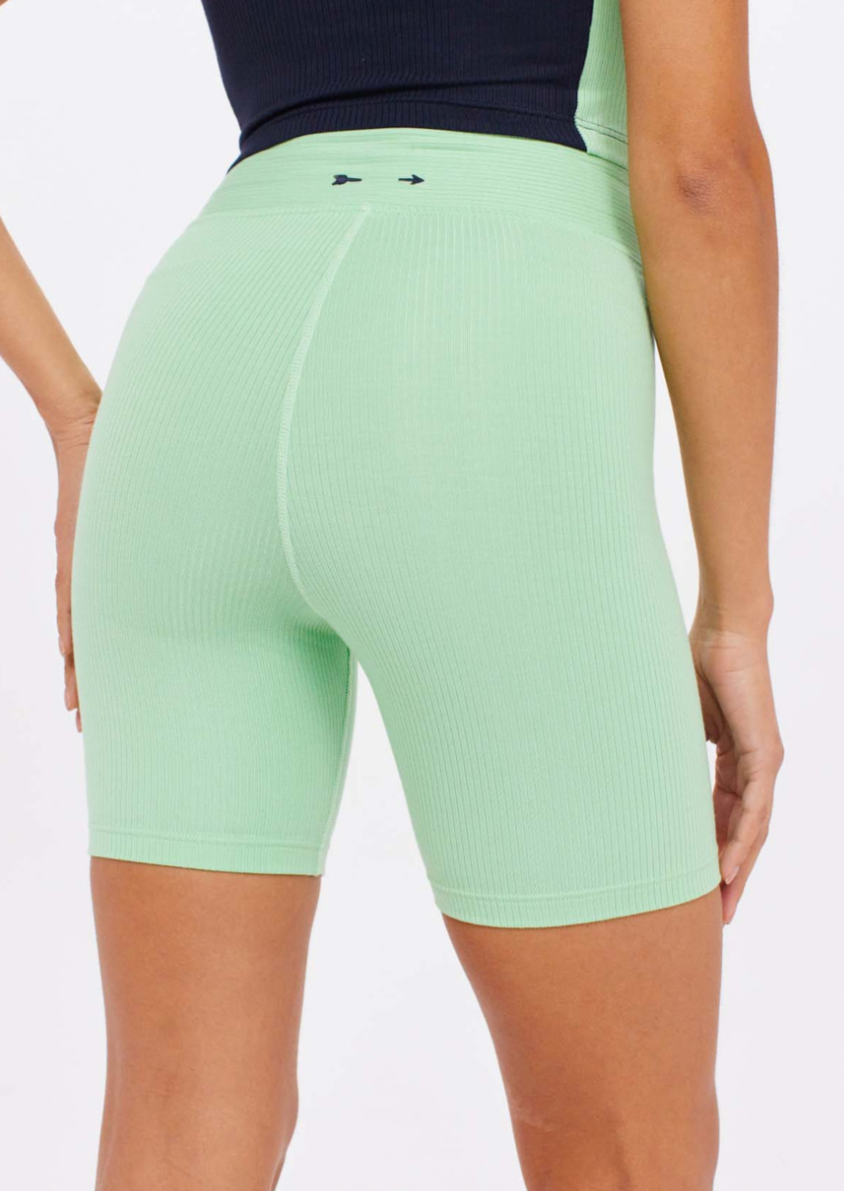 Solstice Spin Short - Neo Mint, by The Upside Freshen up any outfit with our Solstice Spin Short.  Our 6" length spin short Contrast embroidered arrow logo at back Stretchy soft rib fabrication in Neo mint Perfect for soft sport activities Mid rise