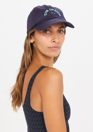 Aloha Soft Cap - Navy, by The Upside Save face in our Aloha Soft Cap..  Soft retro fit cap in navy 'THE UPSIDE' embroidered logo at front in Agave Embroidered hibiscus flower at back in Agave Adjustable velcro strap at back Organic cotton twill fabric