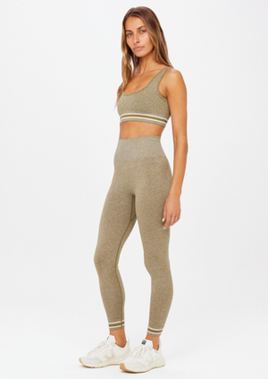 Seamless Midi Pant - Olive Marle, by The Upside Our Seamless Dance Midi Pant has all the smooth moves..  High-rise 7/8 length legwear Olive marle seamless fabrication Contrast knitted stripes down sides Tonal arrow logo on back Moisture control properties