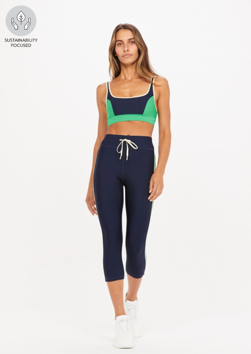 Kala NYC Pant - Navy, by The Upside Cool, calm and confident -- try our Kala NYC Pant on for size.  Mid-rise 3/4 length legwear in navy Contrast panels at sides with piping Arrow logo at centre back Colour blocked in our Eco Tech performance fabric Breathable, quick drying and moisture wicking